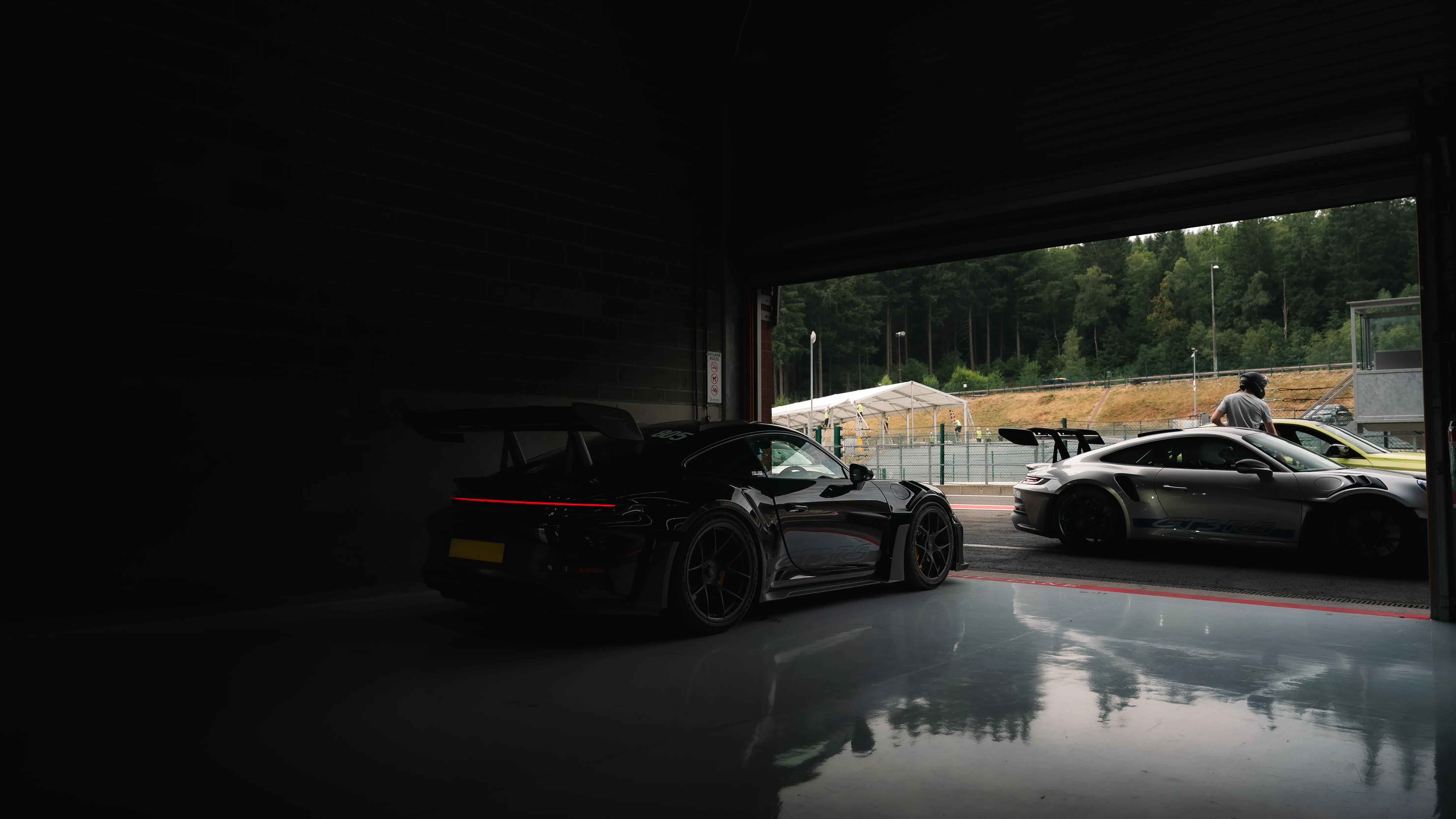Porsches in the pit garages at the circuit